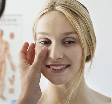 Patient smiling being checked by a dermatologist