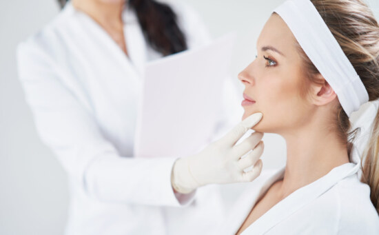 Doctor checking a patient's chin