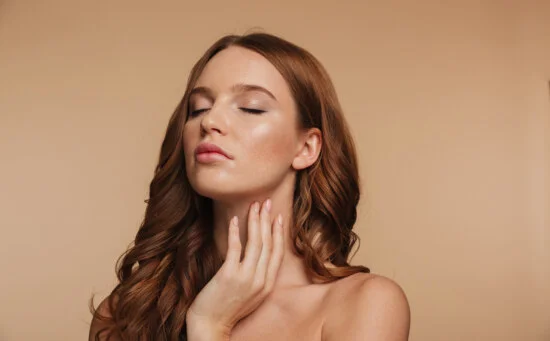 young women with closed eyes and hand on her neck